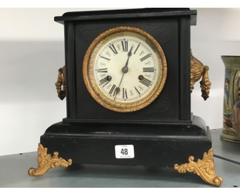 A black painted wood cased imitation slate mantle clock.