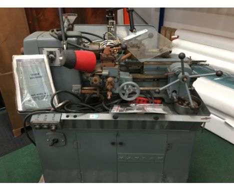 A Raglan 5 inch centre lathe, this machine also comes with variable spindle speeds, all mounted on a metal cabinet which hous