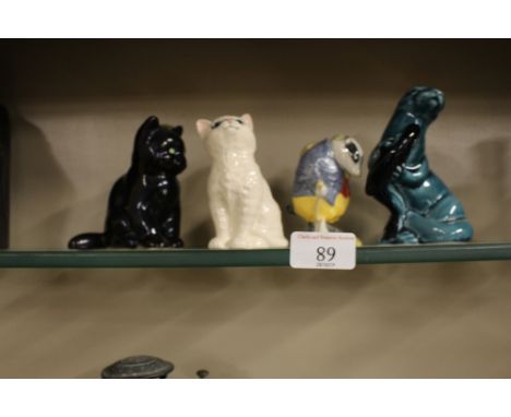 A Beswick Beatrix Potter figure in the form of Tommy Brock; together with a Beswick cat; a Midwinter cat and a Poole pottery 