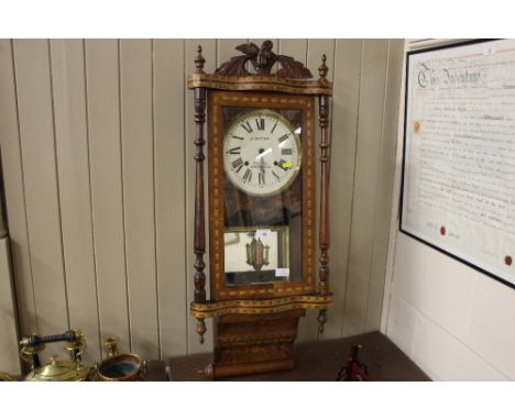A Victorian inlaid walnut clock by J Eaton of Sheffield - key on rostrum
