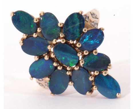 Modern 9ct gold black opal doublet dress ring, a lozenge design set with 11 opals, raised between diamond point set shoulders