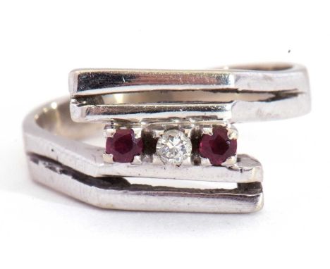 Precious metal stylised small ruby and diamond ring of angular design, highlighted with a small diamond between two small rub