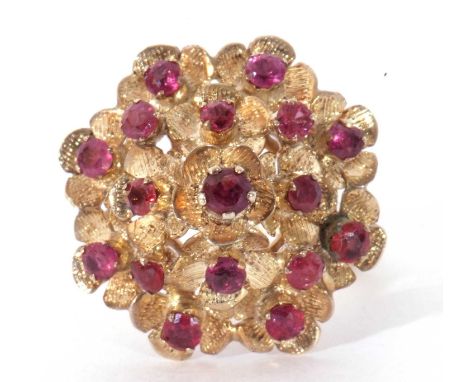 Modern ruby cluster ring, a dome design of floral engraved petals set with 17 small rubies in a basket mount, stamped '8', si