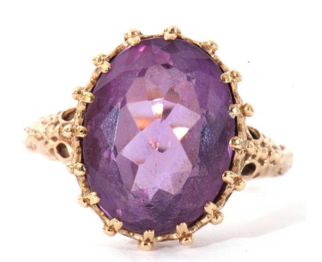 Large amethyst dress ring, the oval faceted amethyst 12 x 10mm, multi-claw set in a bead and pierced ornate mount, stamped 9c