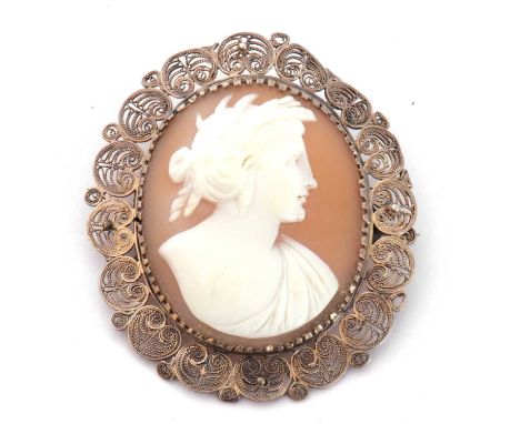 Vintage carved shell cameo brooch depicting a classical portrait figure, in an ornate filigree mount, 45 x 40mm
