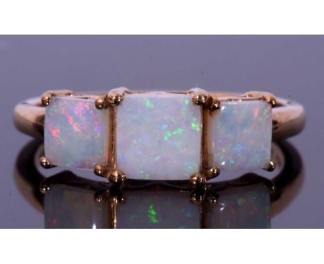 Modern 9ct gold and white opal three stone ring featuring three graduated square cut white opals, size P