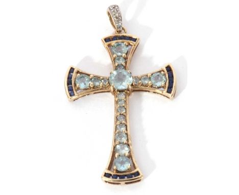 Modern 9k stamped cross pendant featuring 18 graduated light blue stones highlighted at each end with five small dark blue sa