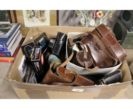 A box of vintage cameras to include Zeiss Ikon, Lomo Cosmic Symbol, telescope, and camera equipment