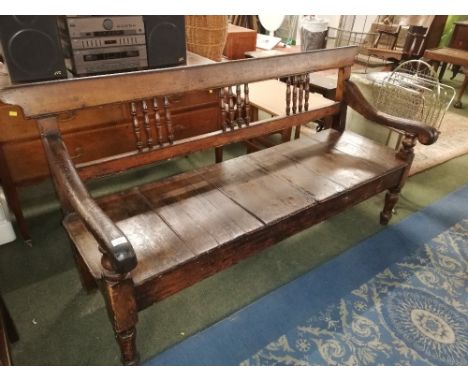 A 19th century stained pine bench, with spindled back, measuring 90 cm tall x 159 cm long x 58 cm deep