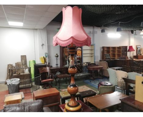 A modern standard lamp with knopped wooden column and pink tasselled shade, 176 cm tall
