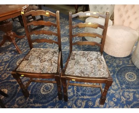 A pair of 20th century ladder back chairs with floral upholstered seats