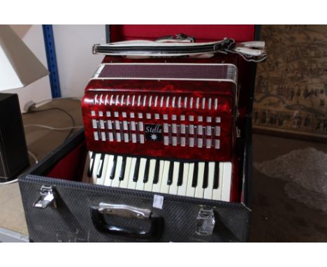 A cased Stella accordion 