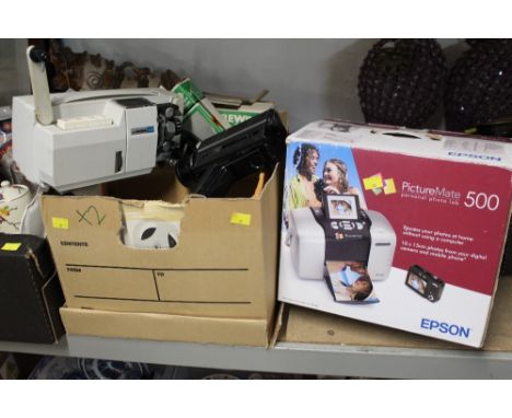 A boxed Epson Picture Mate 500 printer together with a box of projector and reels