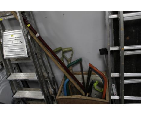 A quantity of garden tools and other tools, including saws, tea chest not included