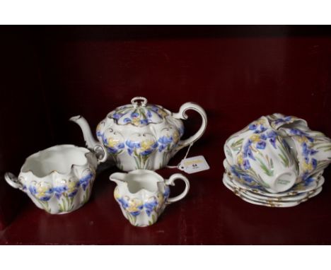 A floral Iris patterned tea set, comprising tea cups and saucers, milk jug, sugar basin and teapot