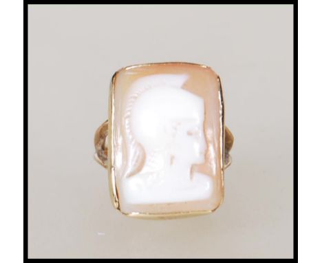 A hallmarked 9ct gold ring set with a carved rectangular cameo to the head depicting a roman soldier. Hallmarked Birmingham 2