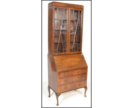 A 20th Century Georgian style Regency Revival mahogany bureau bookcase having twin astragal glazed doors raised on over fitte