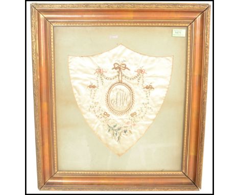 An early / mid 19th Century silk embroidery panel sampler having a central circular panel embroidered with initials SWC surro