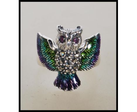 A stamped 925 silver ladies dress ring in the form of a owl having enamel plique a jour wings and tail with illusion set body