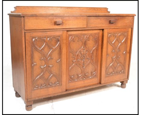 A late 19th Century Victorian oak sideboard credenza in the manner of A.W.N. Pugin, gallery back to the flared top over three