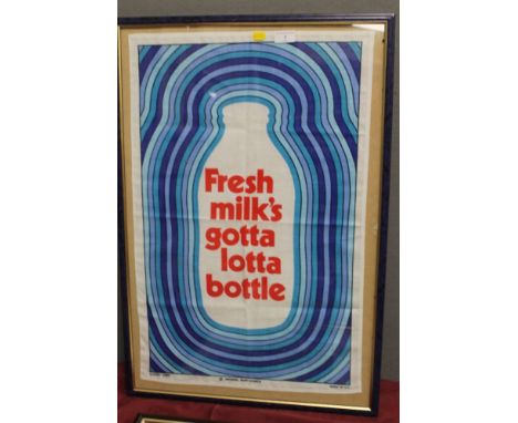 A FRAMED AND GLAZED VINTAGE TEA TOWEL 'FRESH MILK'S GOTTA LOTTA BOTTLE' 