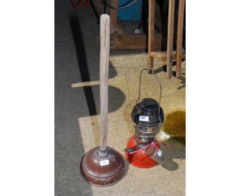 A tilly paraffin lamp and a copper wash dolly.