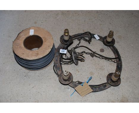 Metal four light chandelier and drum of lighting cable