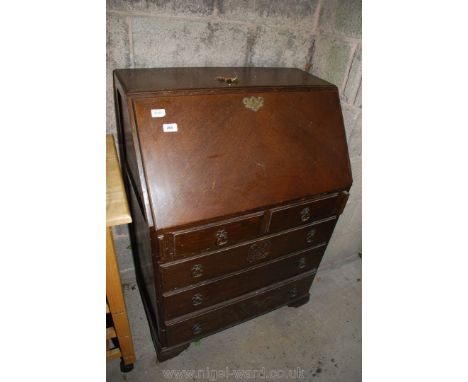 An Oak quarter veneered bureau, two over three drawers, on bracket feet.
