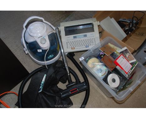 An electric typewriter, cylinder vacuum, various CD's.