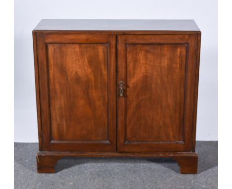 A George III mahogany dwarf cabinet, reeded outlines, two panel doors, bracket feet, width 84cm, depth 50cm, height 92cm.