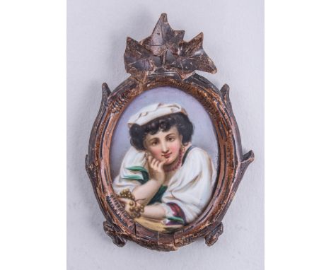 Two German porcelain oval plaques, Tyrolean man and a Neapolitan girl, over print foundations, 8.5cm x 6.5cm in carved wood f