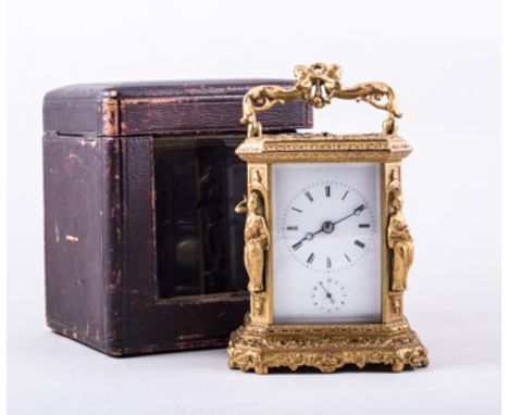 A French gilt metal repeating carriage clock, cast and ornamented case, with cherub caryatid and wreath handle, canted corner