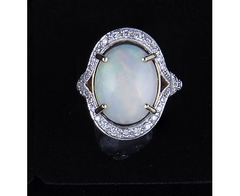 An opal and diamond dress ring, the oval cabochon cut opal, 15mm x 12mm, four claw set in an 18 carat yellow and white gold c