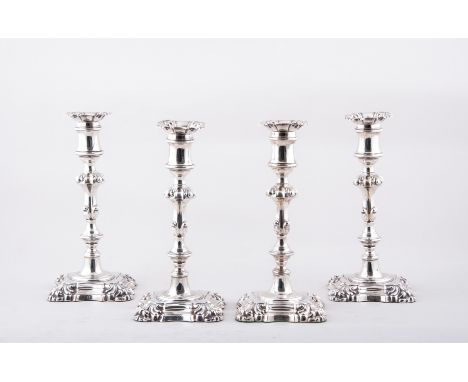 A set of four George III style silver table candlesticks, by Henry Wilkinson & Co., Sheffield 1843, detachable sconces, reel 
