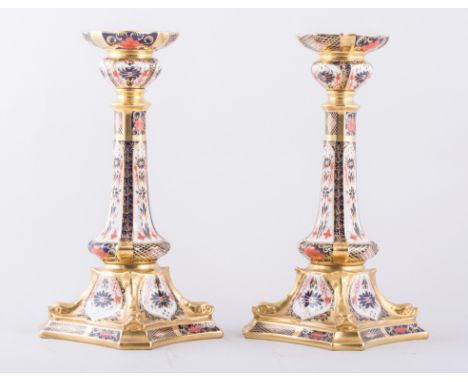 A pair of Royal Crown Derby bone china silver shaped candlesticks, 1987, Old Imari pattern, No. 1128, 27cm.