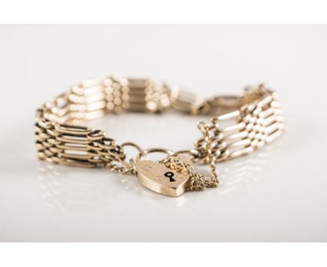 A yellow metal five bar gate link bracelet fitted with a hallmarked 9 carat yellow gold padlock fastener and safety chain, wi