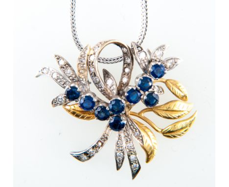 A sapphire and diamond pendant, yellow and white metal floral spray with sapphires (9), individually raised claw set and diam