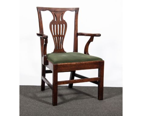 A George III Country made Chippendale style elbow chair,  pierced vase splat, open arms, drop in seat upholstered in a celado