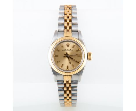 Rolex - A lady's Oyster Perpetual wristwatch, the circular champagne baton dial with sweep seconds hand in a bi-metal case wi