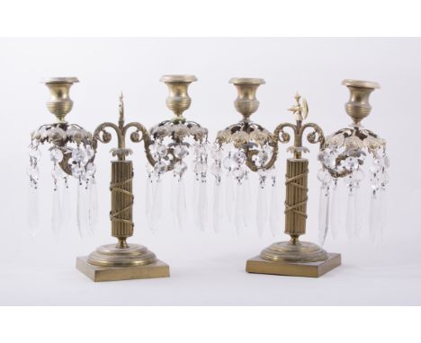 A pair of French Empire style gilt metal two light candelabra, fluted columns, the sconces with rose cast tendrils, issuing p
