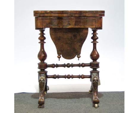 A Victorian figured walnut serpentine work table, fold over top enclosing an inlaid chequer board, cribbage board and backgam