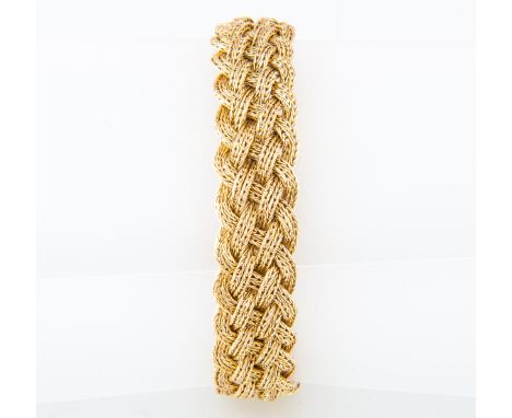 A yellow metal fancy link bracelet, of ornate plaited design, 15mm wide, having a concealed box snap fastener and safety chai