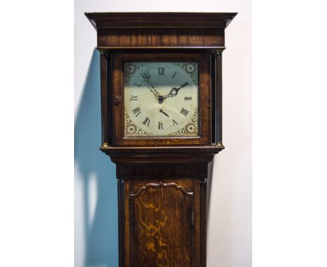 An oak longcase clock, the hood with cavetto moulded cornice, turned columns, long door with mahogany crossbanding flanked by