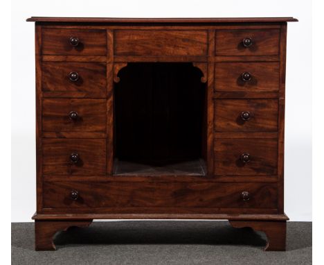 A late Georgian mahogany chest/cabinet, fitted with banks of four drawers over a central blind drawer and recess, single long