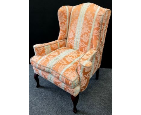 A George III style wingback armchair, ‘The Wellington’ model, by Earlham, of High Wycombe, 106cm high x (50cm to seat) x 81cm