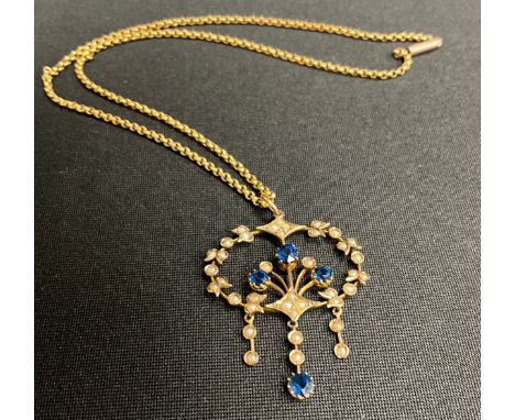 An Edwardian seed pearl and blue stone three drop floral pendant necklace, unmarked yellow metal mount and chain, approx 40cm