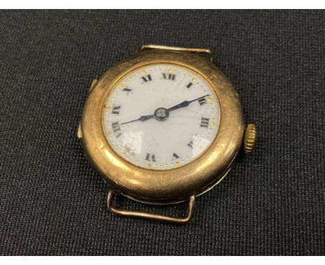 A 1920s 9ct gold cased watch head, white dial, manual wind movement, case London 1925, 12.7g gross. 