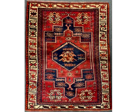 A South West Persian Lori rug / carpet, hand-knotted with a central hexagonal medallion in deep blue, within a field of abstr