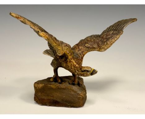 An Austrian cold painted bronze, of an eagle, perched on a rock with wings outstretched, 19cm wide 