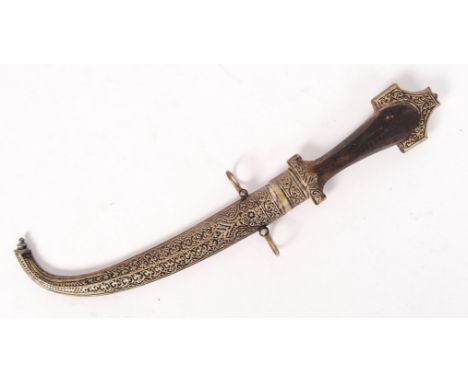 An antique 19th century Middle Eastern Jambiya ceremonial dagger. White metal decoration to handle and scabbard, with an ebon